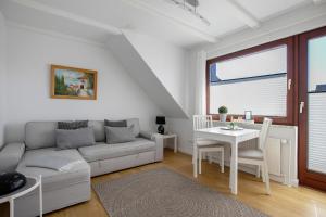 a living room with a couch and a table at Haus am Hemm in Meldorf