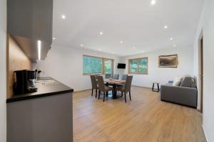 a kitchen and living room with a table and a couch at Tholerhof in Schenna
