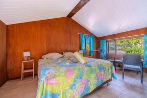 a bedroom with a bed with a stuffed animal on it at Matira house in Bora Bora