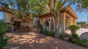 a house with a picnic table and a tree at Vinyes Can Grau in Sencelles