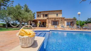 a villa with a wicker basket next to a swimming pool at Vinyes Can Grau in Sencelles