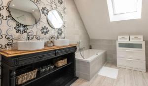 a bathroom with two sinks and a tub and a mirror at Gîte La voisine in Venteuil +37 photos
