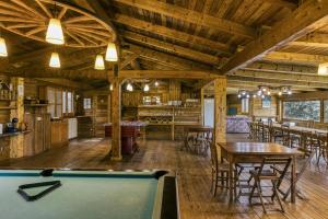 a pool table in a room with wooden ceilings at Habitacions Mas Fuselles in Girona