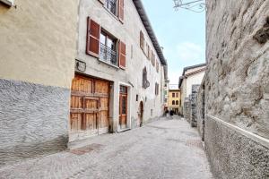an alley in an old building with wooden doors at Premesan 5 in Bormio