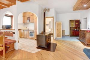 a kitchen with a stove in the middle of a room at Premesan 5 in Bormio