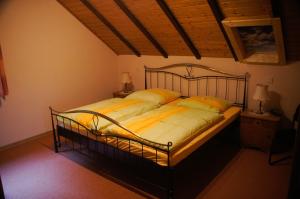 a bedroom with a large bed with yellow sheets at Rauber Marie Theres in Abentheuer