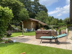 a backyard with a hot tub and a bench at Rauber Marie Theres in Abentheuer