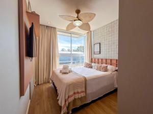 a bedroom with a bed and a large window at Casa Verde Mar Naluum in Passo de Camarajibe
