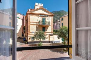 a view of a building from an open window at Appartamento Piazza Bertamino in Bonassola