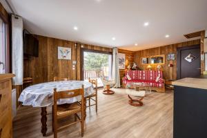 a kitchen and living room with a table and a couch at Chalet d'Aillon in Aillon-le-Jeune +19 photos