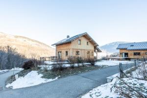 a house on the side of a road in the snow at Chalet du Fey in Valmorel