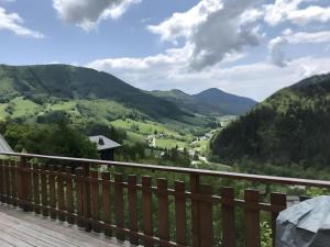 a view from the deck of a house overlooking a valley at Chalet d'Aillon in Aillon-le-Jeune
