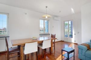 a dining room with a wooden table and chairs at Villa Lucia in Ameglia