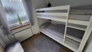 an empty bunk bed in a room with a window at Ferienwohnung Friedhoff, 80qm in Schmallenberg