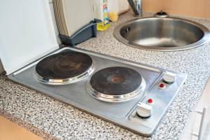 two pans sitting on top of a stove in a kitchen at Ferienwohnungen in Starsow in Mirow +85 photos
