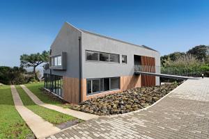 ein Haus auf einem Hügel mit einer steinernen Auffahrt in der Unterkunft Rocha do Mar 1 in Biscoitos