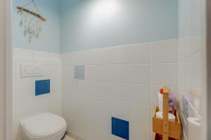 a bathroom with a white toilet and blue tiles at Les Ebihens in Saint-Benoît-des-Ondes +16 photos