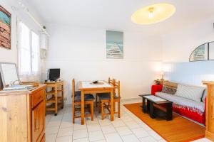 a living room with a couch and a table at Location Oléron, proche plage in Dolus-d'Oléron