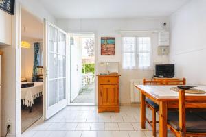 a dining room with a table and a room with a bedroom at Location Oléron, proche plage in Dolus-d'Oléron