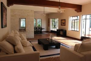 a living room with a couch and a table at Villa Marines Cuernavaca in Cuernavaca