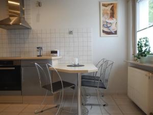 a kitchen with a table and chairs in a kitchen at Viktoria in Koblenz +14 photos