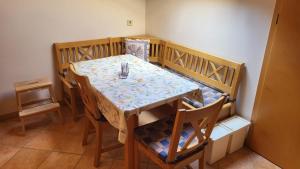 a dining room table and chairs with a table and a table and chairsuggest at Ferienwohnung Strobl in Dießen am Ammersee