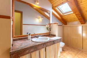 a bathroom with a sink and a mirror and a toilet at La Casa de Dafne Almendro in Santo Tomé del Puerto +24 photos