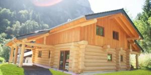 a large wooden cabin with a gambrel at Seehaus Alm in Ruhpolding +5 photos