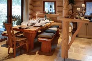 a dining room with a wooden table and chairs at Seehaus Alm in Ruhpolding