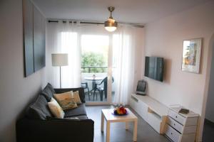 a living room with a couch and a table at Sol Isla - Binimar in Arenal d'en Castell