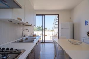 a kitchen with a sink and a counter top at Villa Scoglio in Melendugno