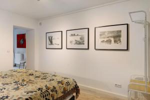 a bedroom with four pictures on the wall at Ferienwohnung im Denkmal in Havelberg