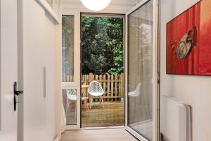 a glass door leading to a patio with a table and chairs at Ferienwohnung im Denkmal in Havelberg +11 photos