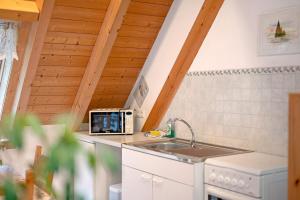 a kitchen with a sink and a microwave at Hornihäusle in Aufʼm Bühl +56 photos