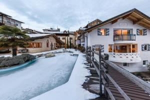 a house with a snow covered driveway in front of it at Naturoase Stegerhof Apt Sonnenblume in Trodena