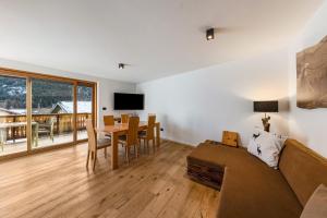 a living room with a couch and a table at Naturoase Stegerhof Apt Sonnenblume in Trodena