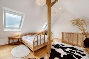 a bedroom with a wooden bed in a attic at Großzügige Maisonettewohnung in Sindelfingen