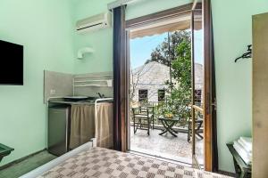 a kitchen with a sliding glass door leading to a patio at Old Boat double studio 6 in Nikiana