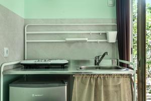 a kitchen with a sink and a counter with a trash can at Old Boat double studio 6 in Nikiana +12 photos