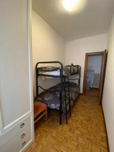 a small room with two bunk beds in it at Ciasa Da Rin in Auronzo di Cadore