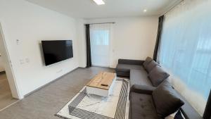 a living room with a couch and a coffee table at Ferienhaus Koca in Imsterberg