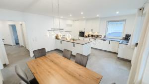 a large kitchen with a wooden table and chairs at Ferienhaus Koca in Imsterberg