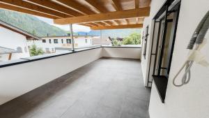 a balcony with white walls and a wooden ceiling at Ferienhaus Koca in Imsterberg