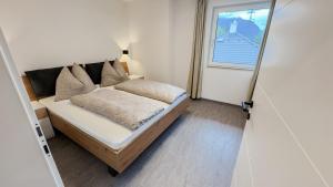 a small bedroom with a bed and a window at Ferienhaus Koca in Imsterberg