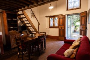 a living room with a red couch and a table at Vallone di Cecione in Greve in Chianti
