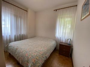 a small bedroom with a bed and a window at Ciasa Da Rin in Auronzo di Cadore +15 photos