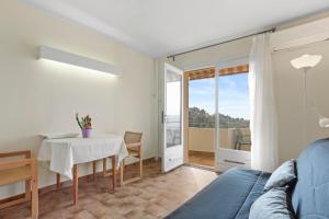 a living room with a table and a couch at Le Mas Berliat N°9 in Bormes-les-Mimosas +22 photos