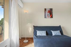 a blue couch in a living room with a lamp at Le Mas Berliat N°9 in Bormes-les-Mimosas