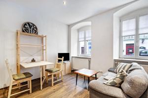 a living room with a couch and a desk at Fichtel7 in Wunsiedel
