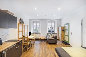 a kitchen and living room with a table and chairs at Fichtel7 in Wunsiedel